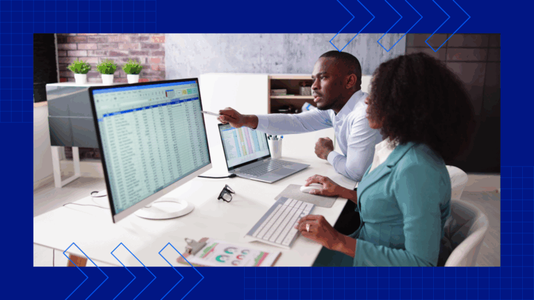 Two life insurance agents looking at a screen full of metrics while sitting at a desk
